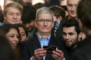 apple ceo tim cook showing iphone