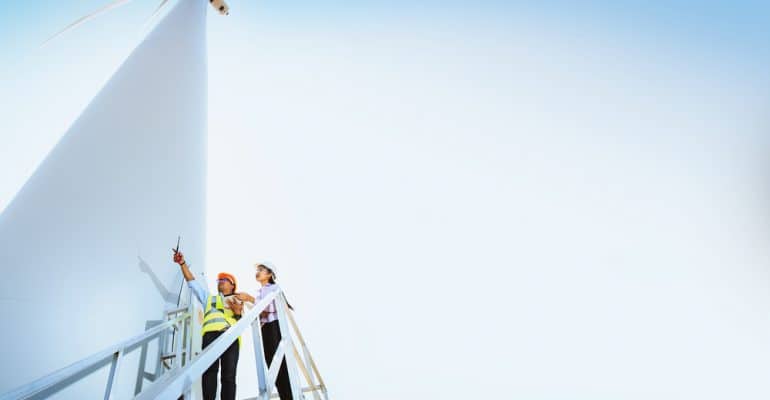 employees working on a wind mill