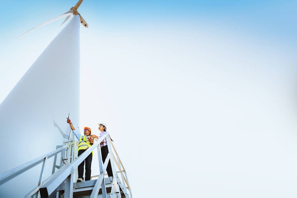 employees working on a wind mill