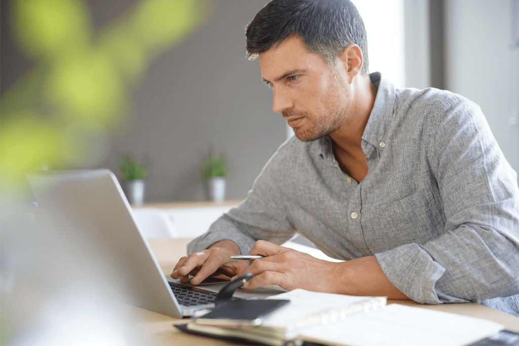 A mature man working on his laptop