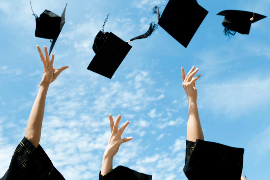 College graduates throwing their caps in the air