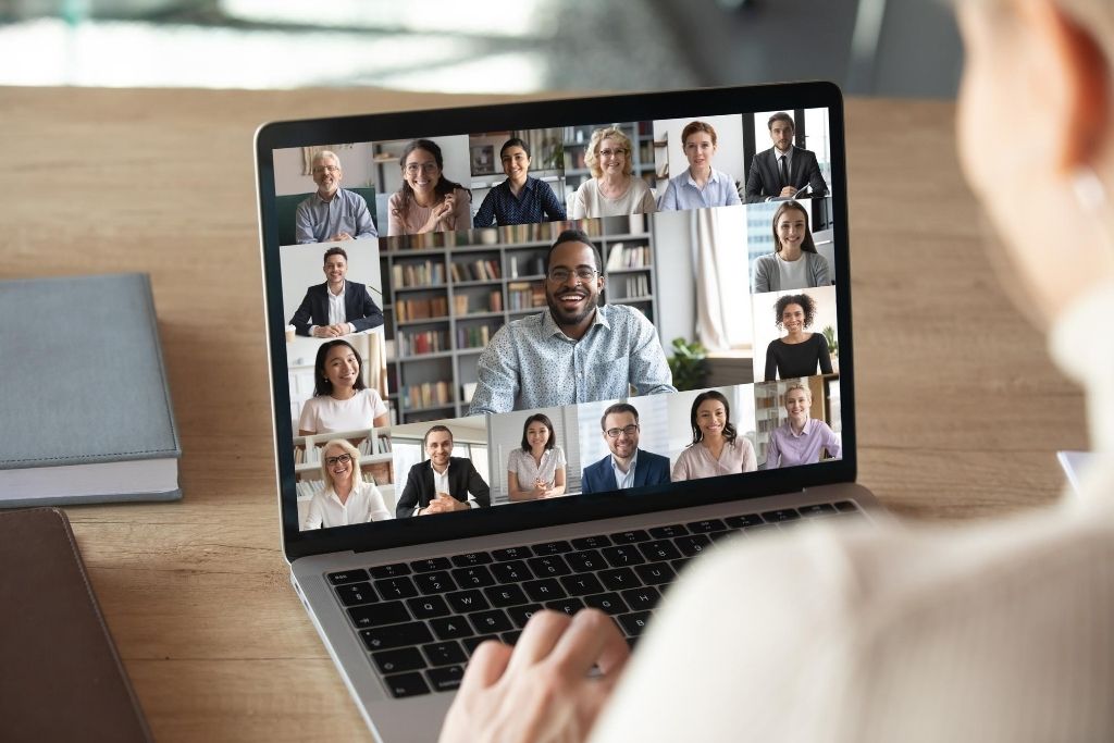 Student on computer interacting with a wide variety of people.