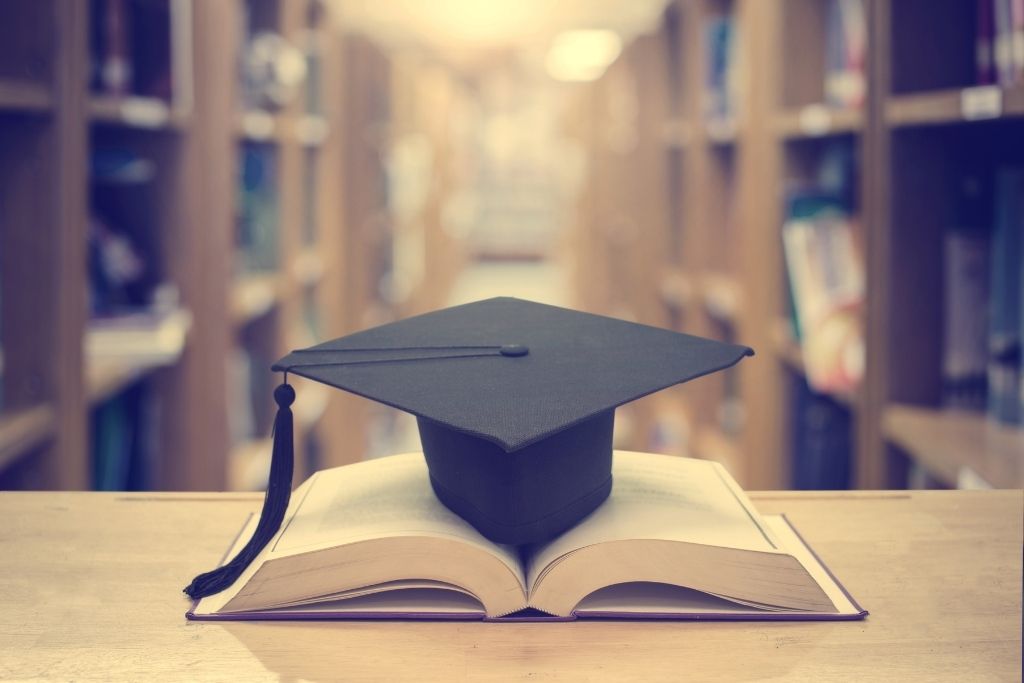 Library with books and a graduation cap.