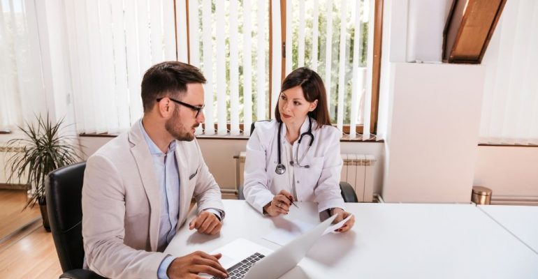 A healthcare consultant talking to a doctor.