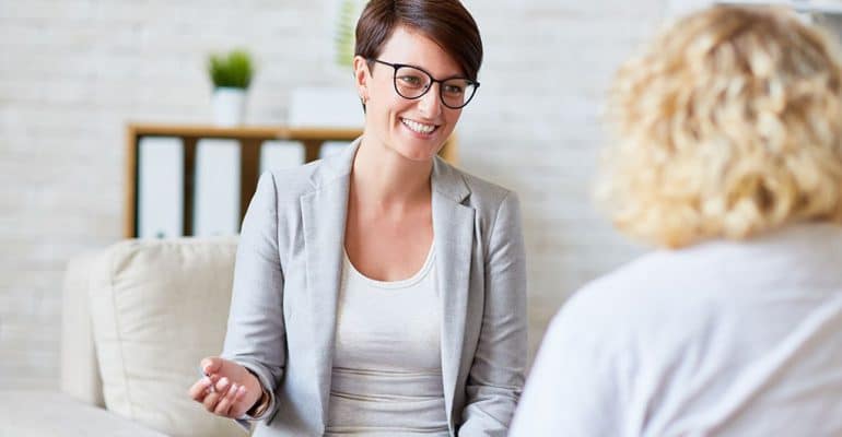 A counselor with a public health background speaking with a client.