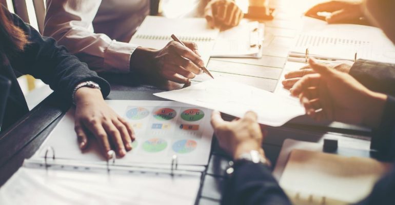 Business professionals having a meeting at a table.