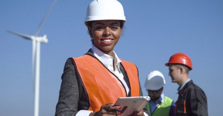 A female renewable energy graduate works on a wind farm