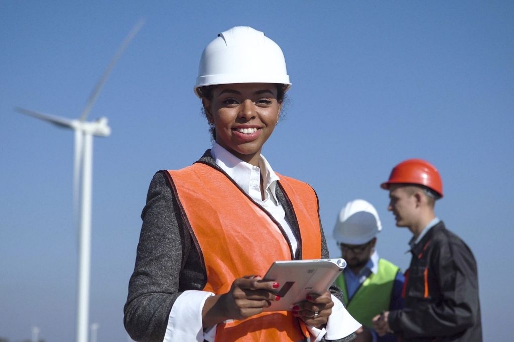 A female renewable energy graduate works on a wind farm