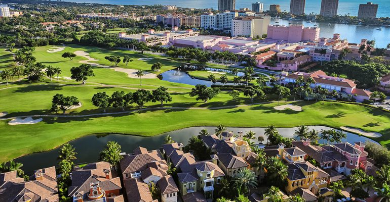 An aerial view of Boca Raton, Florida, over a golf course, homes, and the Atlantic Ocean