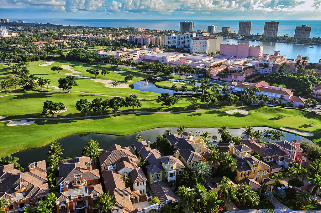 An aerial view of Boca Raton, Florida, over a golf course, homes, and the Atlantic Ocean