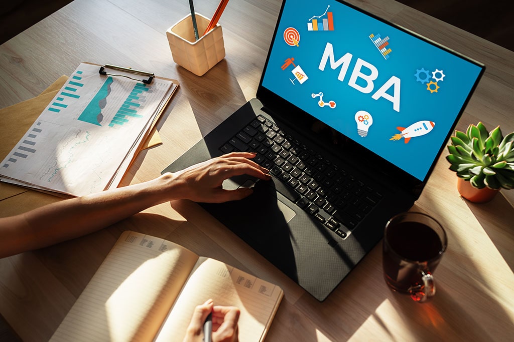 Woman studies for an MBA at a table.