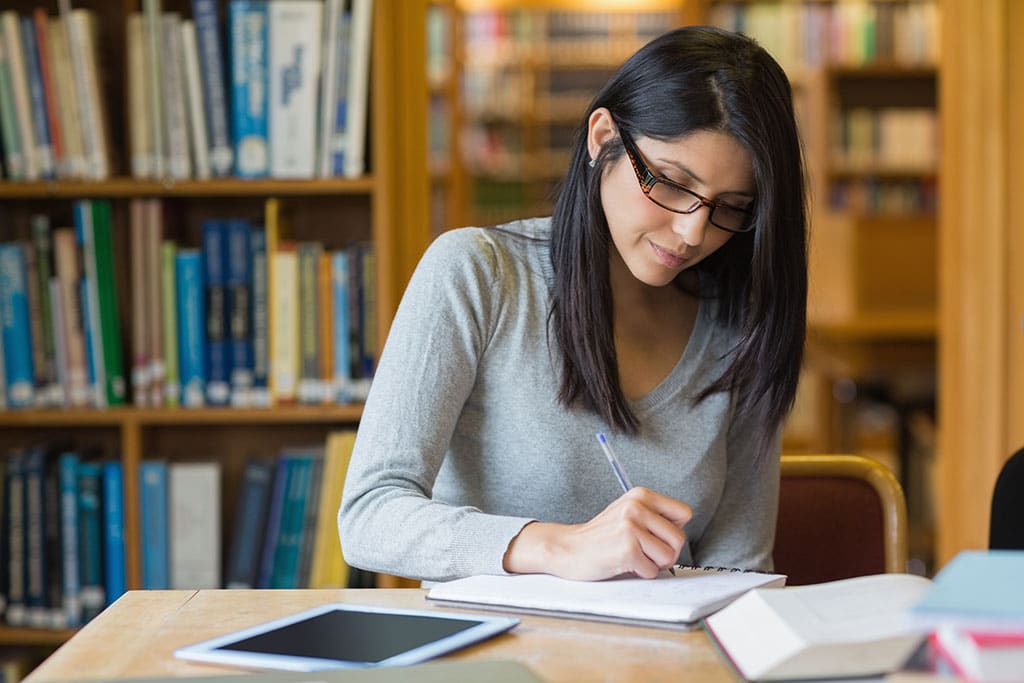 A woman studying at a library