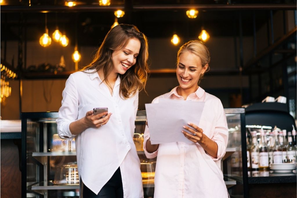 Two hospitality managers looking at their reservations for the night at the restaurant.