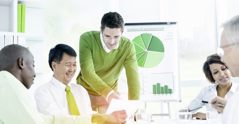 Businessmen discuss green policies in a meeting room