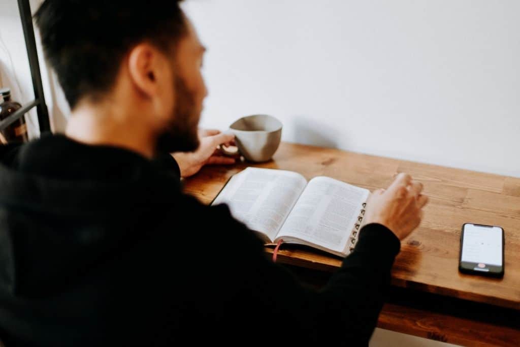 Man studies book at a table