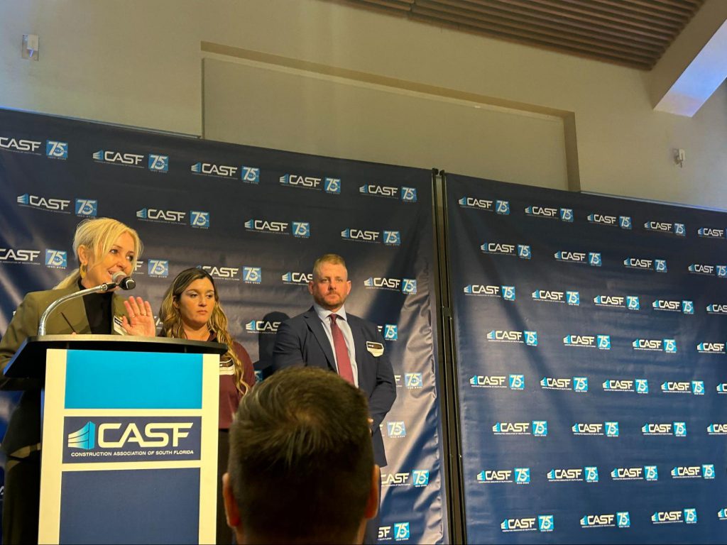 Everglades University President Kristi Mollis speaking at a podium during the CASF dinner.