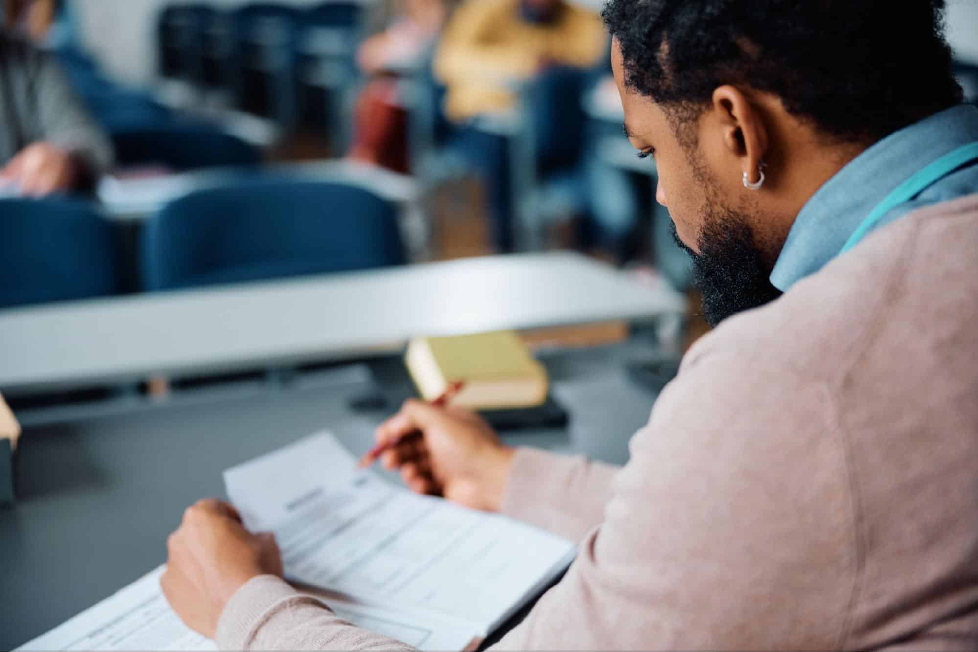 A student studying financial and management materials in a classroom, representing core subjects in an MBA program.