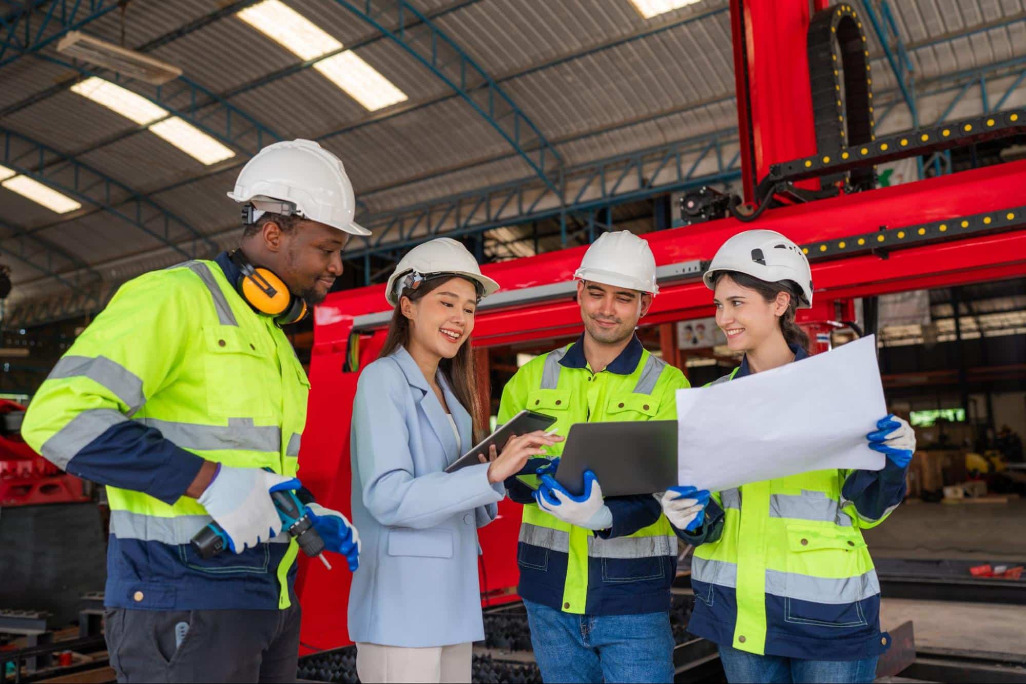 A group of engineers reviewing plans and safety measures in an industrial facility as part of the disaster management cycle.
