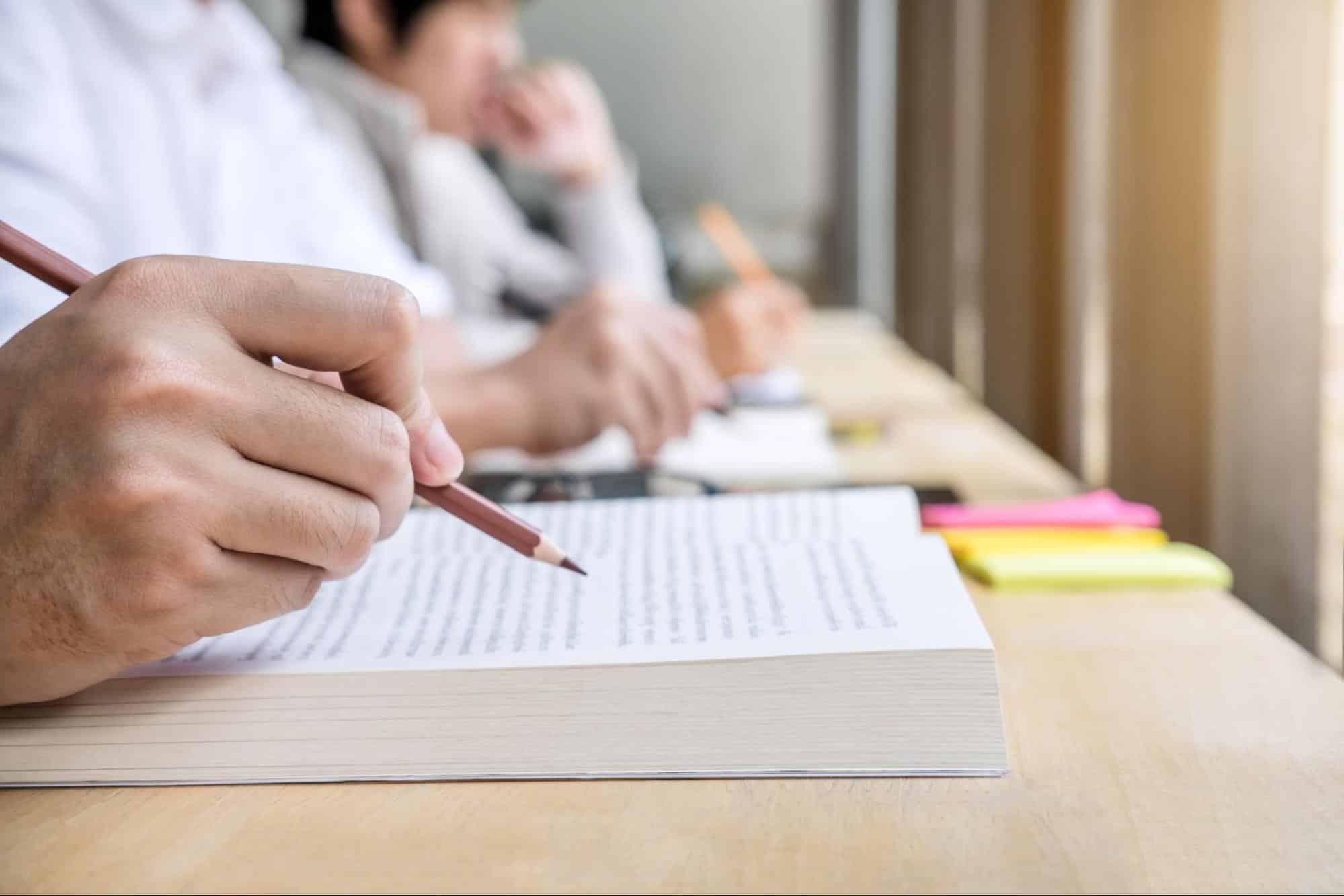 Students taking notes during a lecture, focusing on the core subjects in an MBA program.