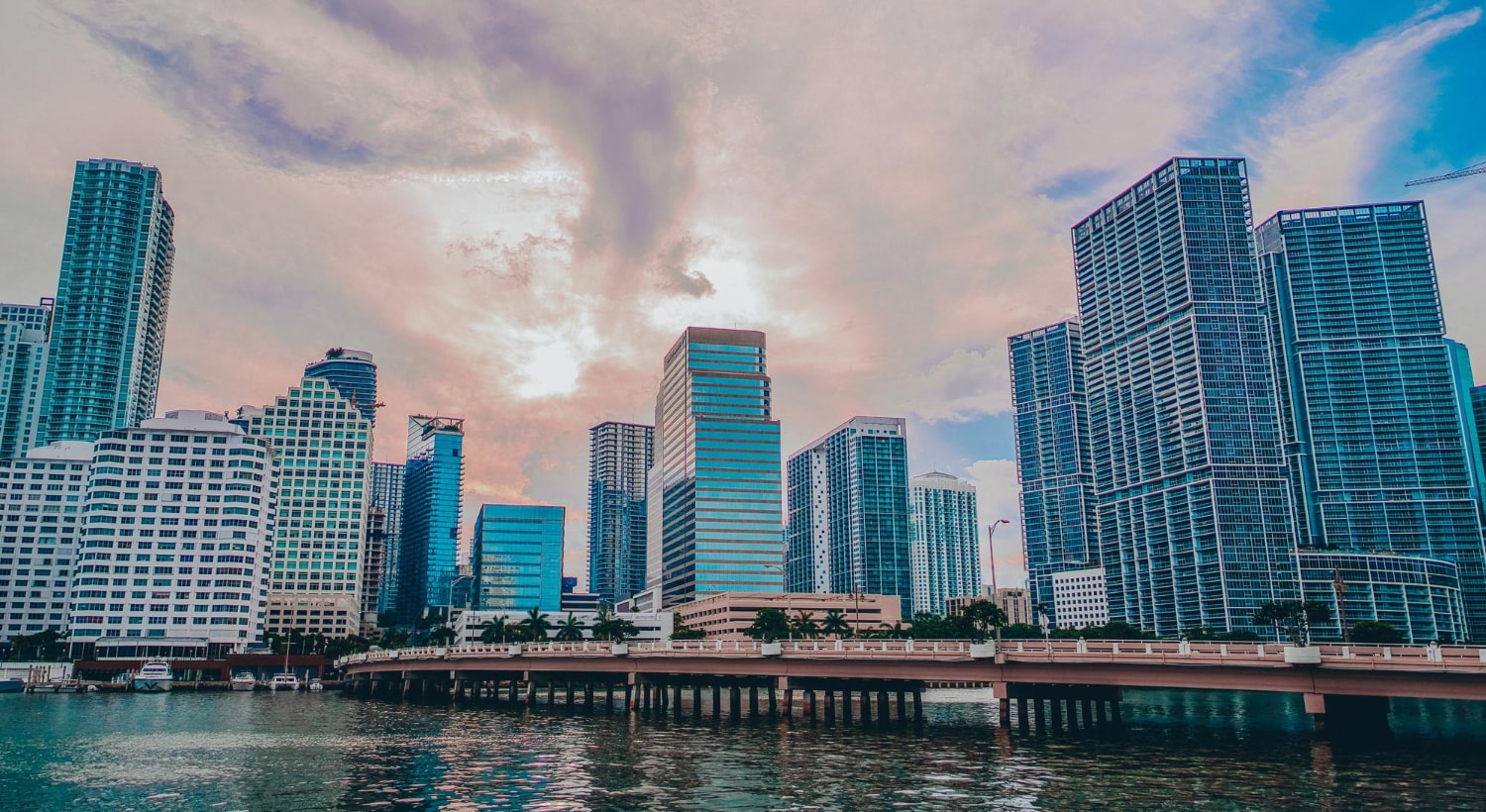 The Miami skyline under cloudy skies, representing Florida businesses that require comprehensive business continuity and disaster recovery strategies due to coastal weather risks and rising sea levels.