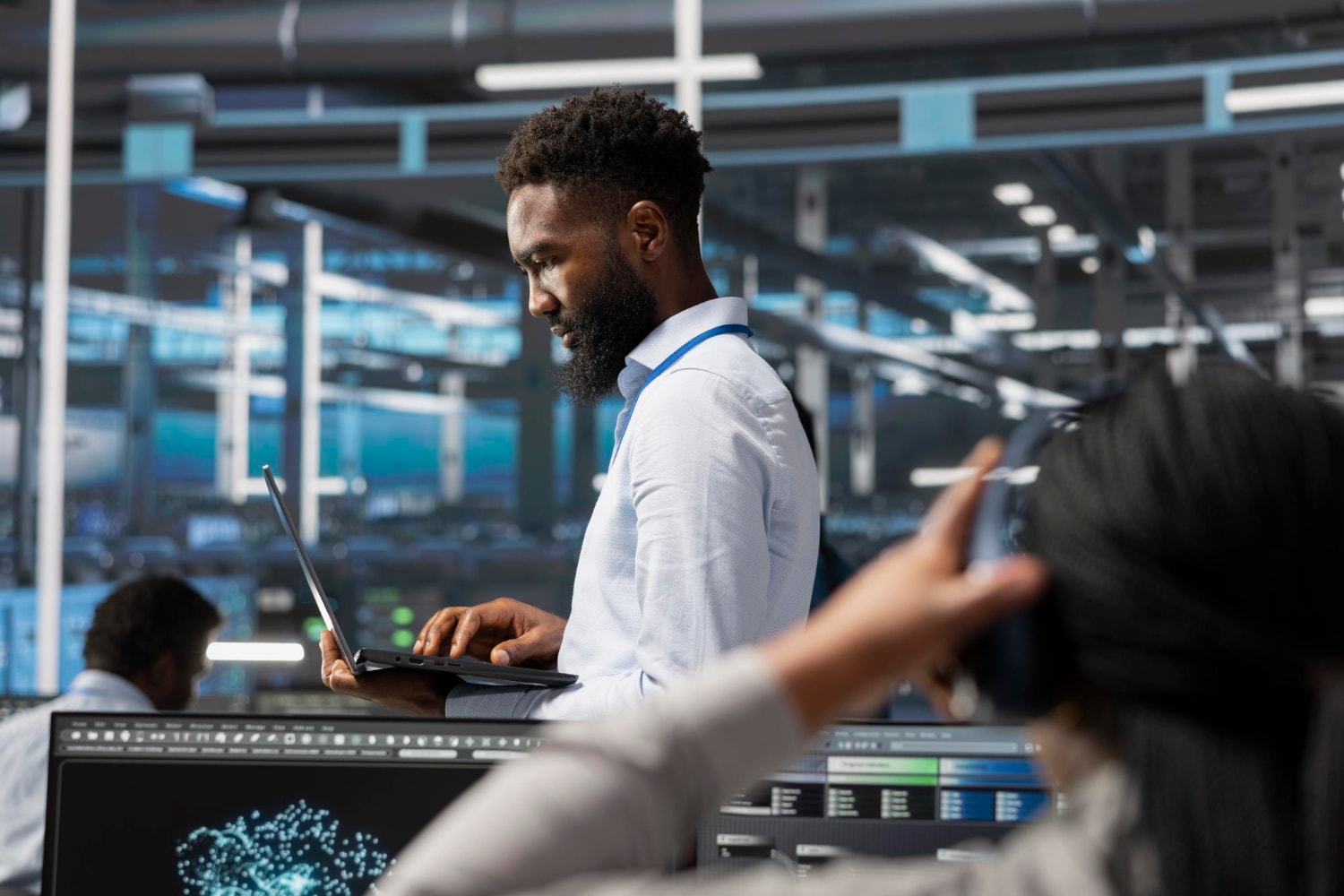 A disaster recovery specialist working in a high-tech data center, focusing on IT infrastructure restoration and maintaining data security during a technical disruption.