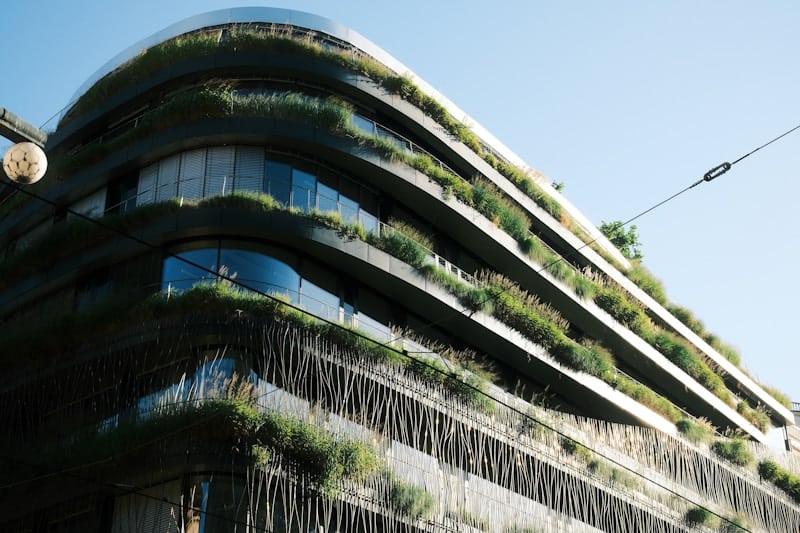 Energy efficient green building with integrated vegetation showcasing sustainable modular construction design
