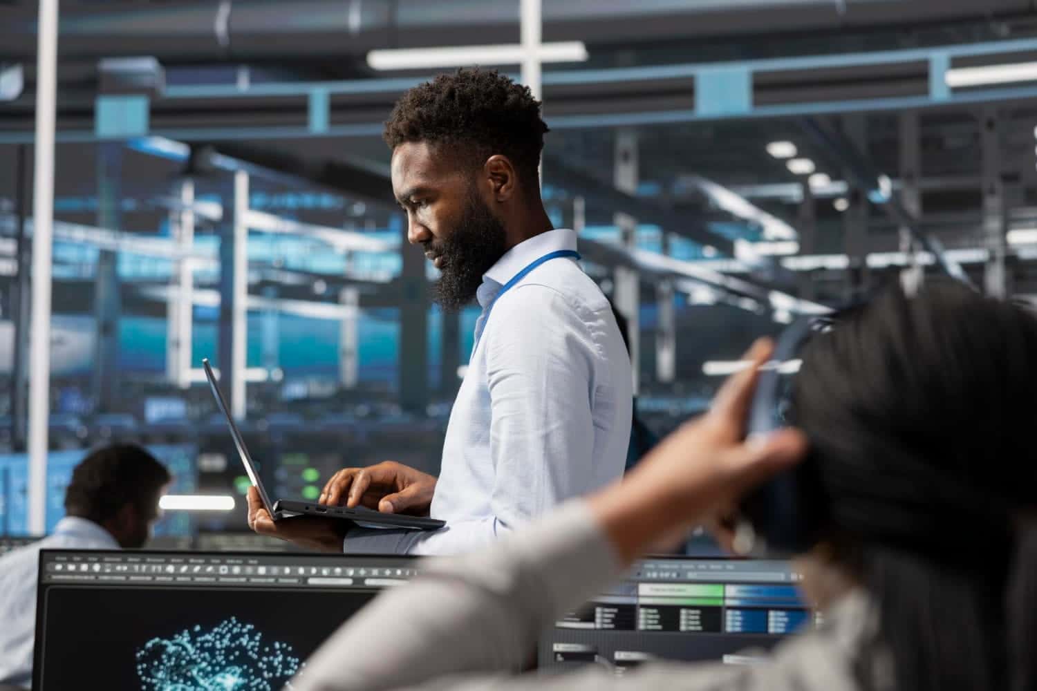A disaster recovery specialist working in a high-tech data center, focusing on IT infrastructure restoration and maintaining data security during a technical disruption.