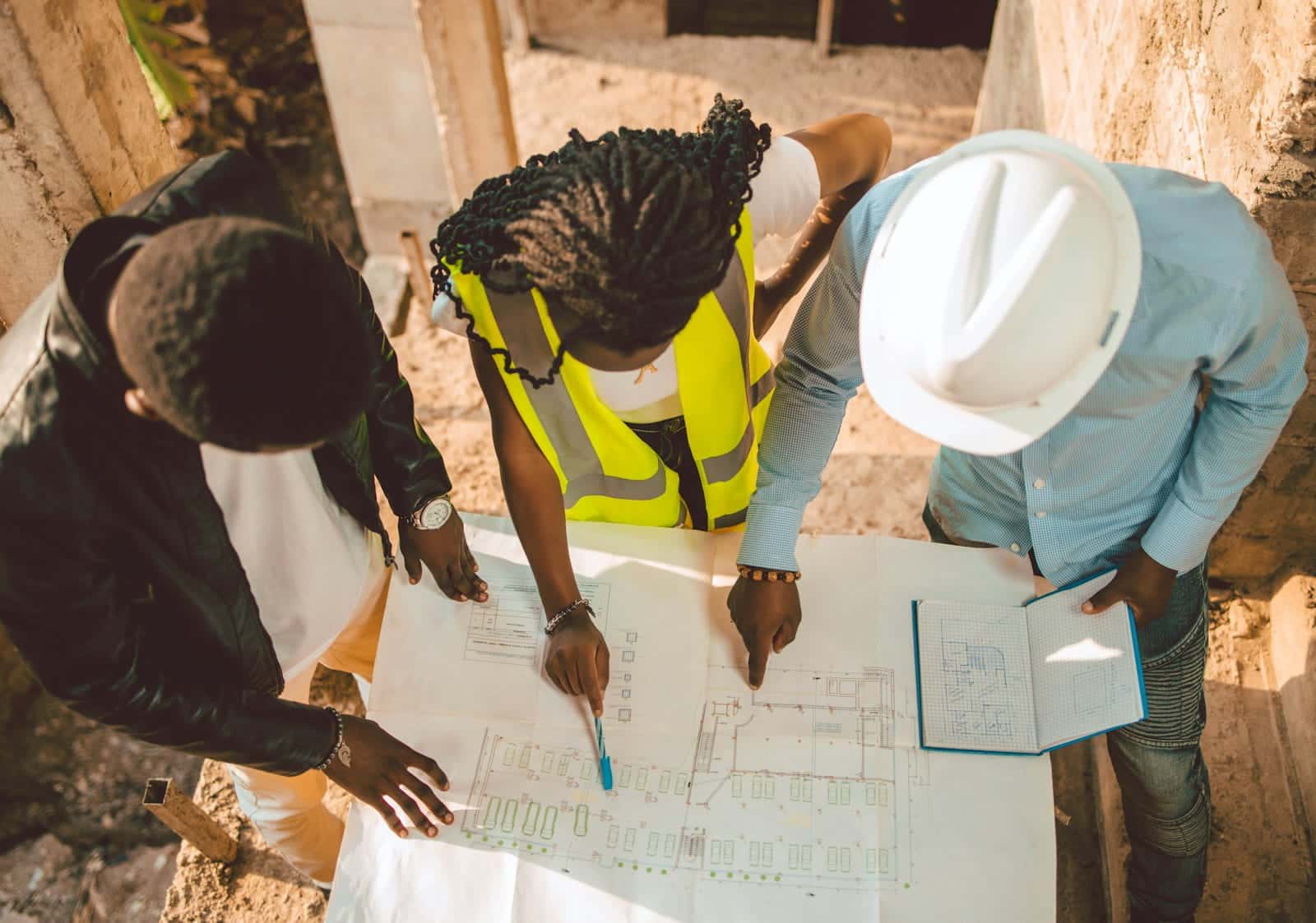 AEC professionals and engineers reviewing construction project plans together at a conference table