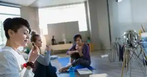 People practicing yoga and meditation in a bright wellness studio