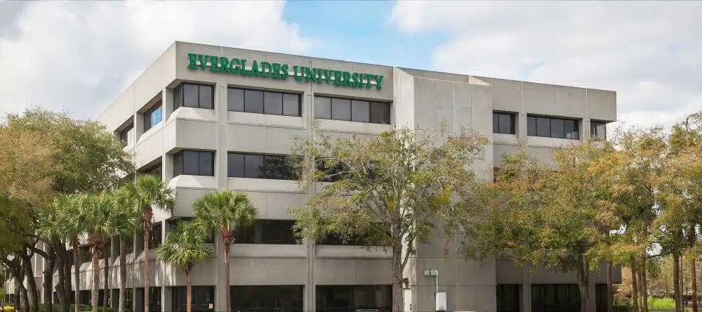 Everglades University branch campus building framed by trees